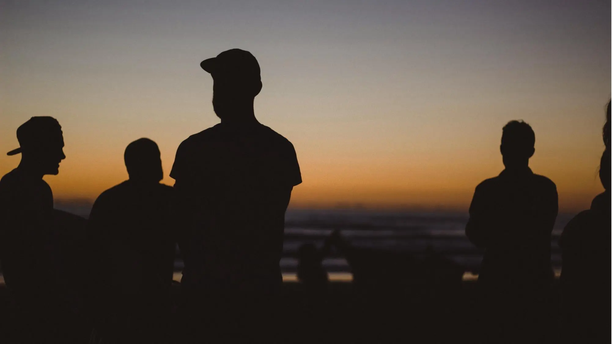 People standing in sunset