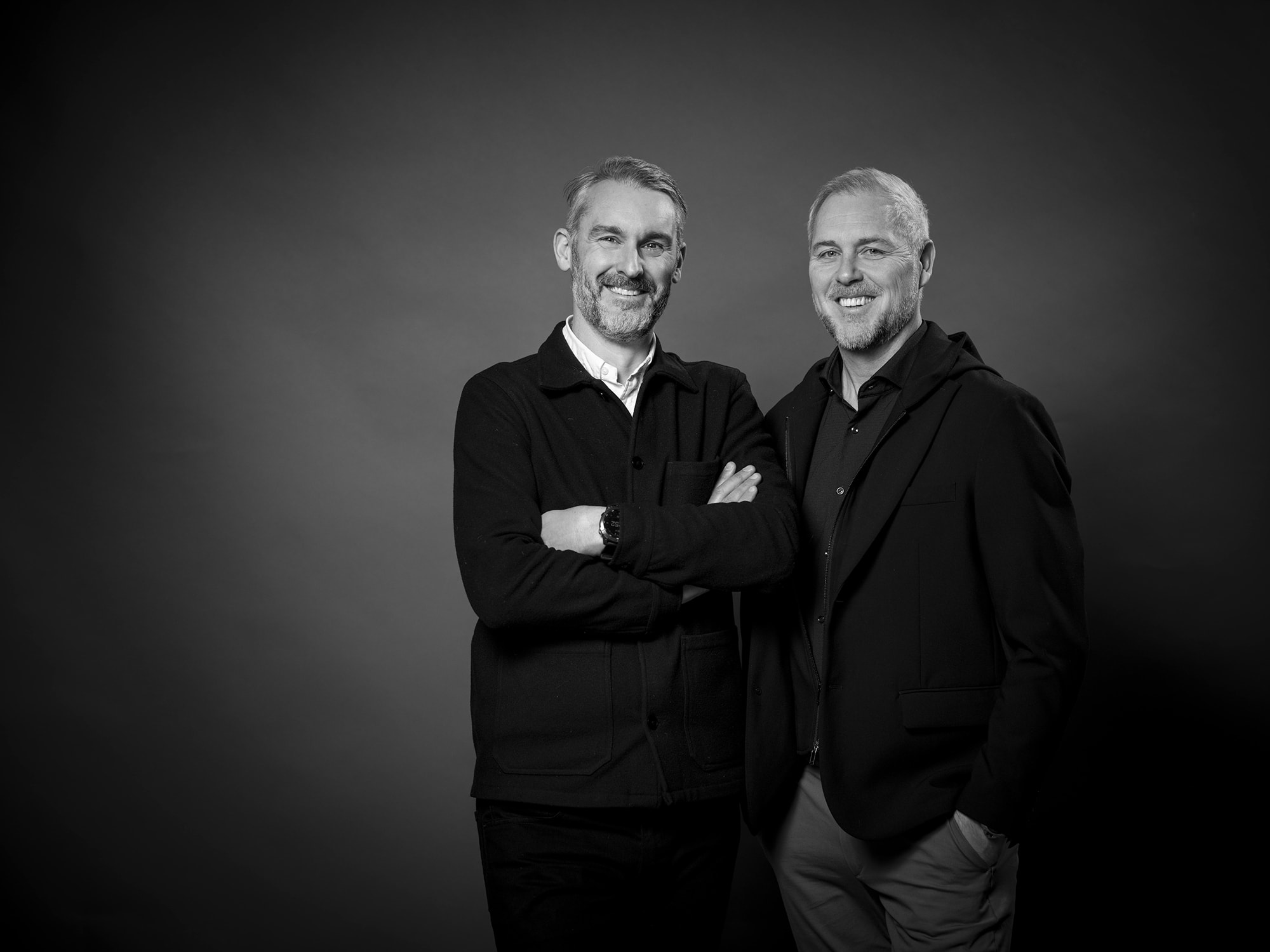 Two men smiling