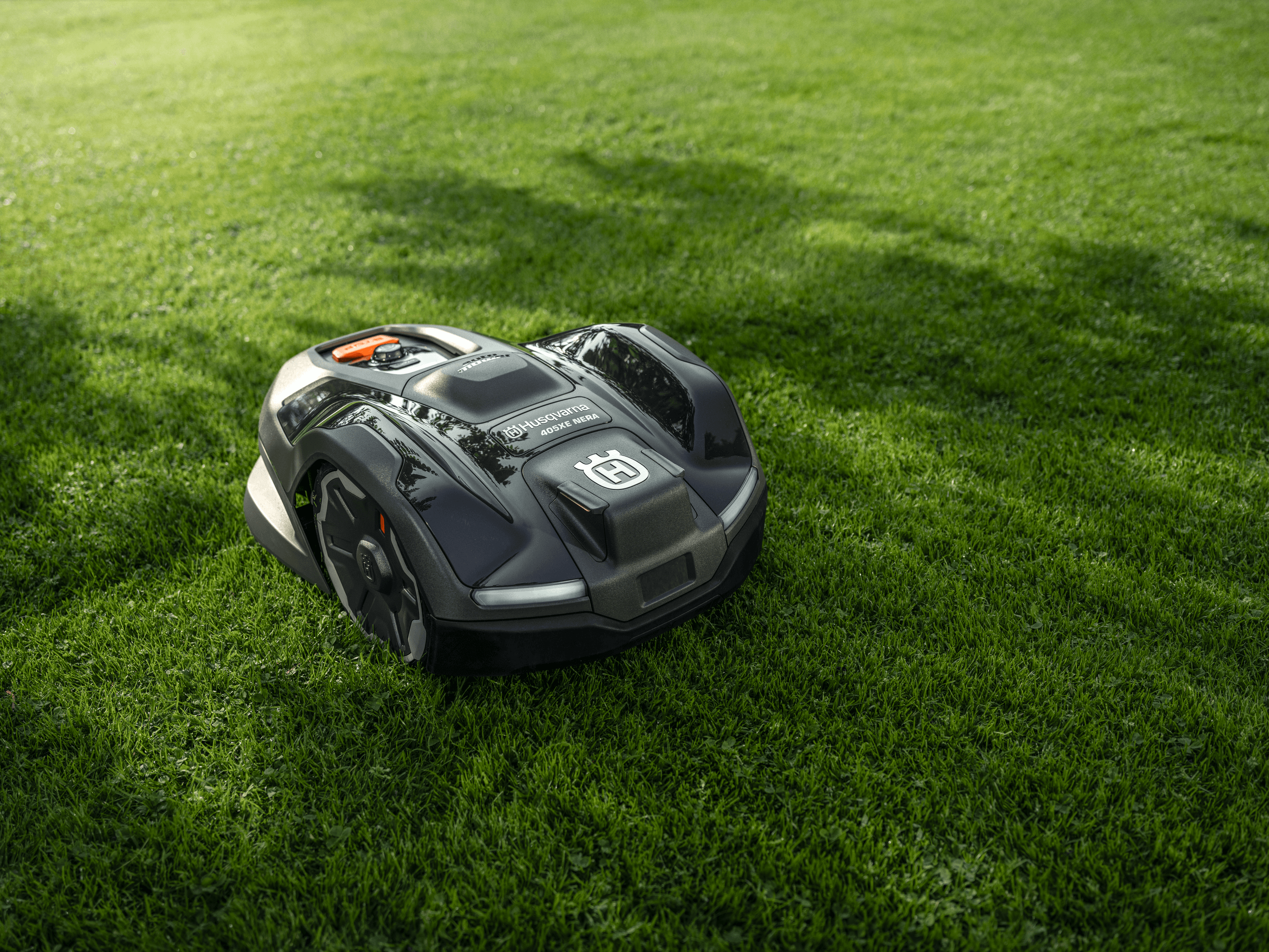 A robot lawn mower on a field of grass.